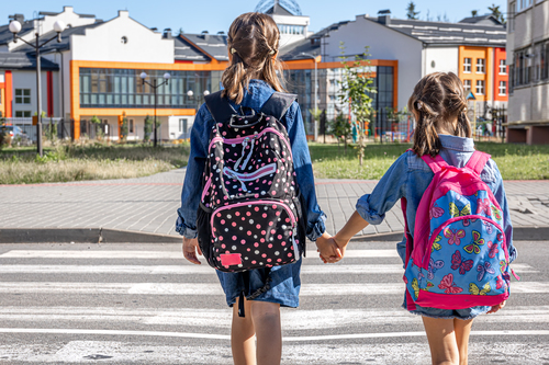 Primary school students go to school, holding hands, first day of school, back to school.